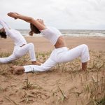 outdoor-picture-beautiful-sporty-european-female-her-teenage-athletic-son-practicing-hatha-yoga-by-sea-together-standing-virabhadrasana-ii-warrior-2-pose-deserted-sandy-beach (1)